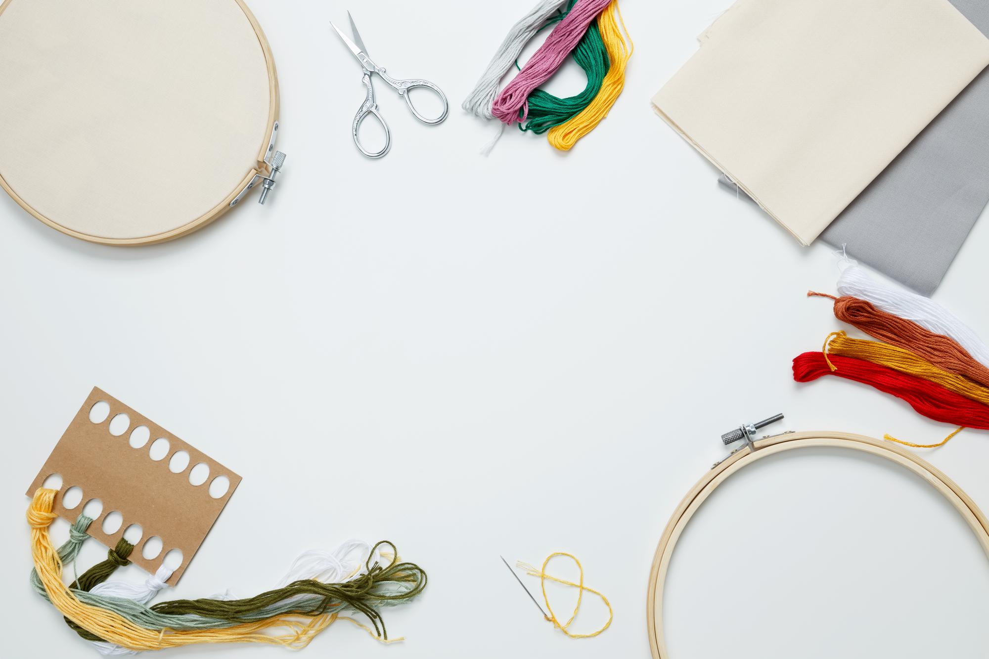 Atelier workspace with embroidery hoops and thread