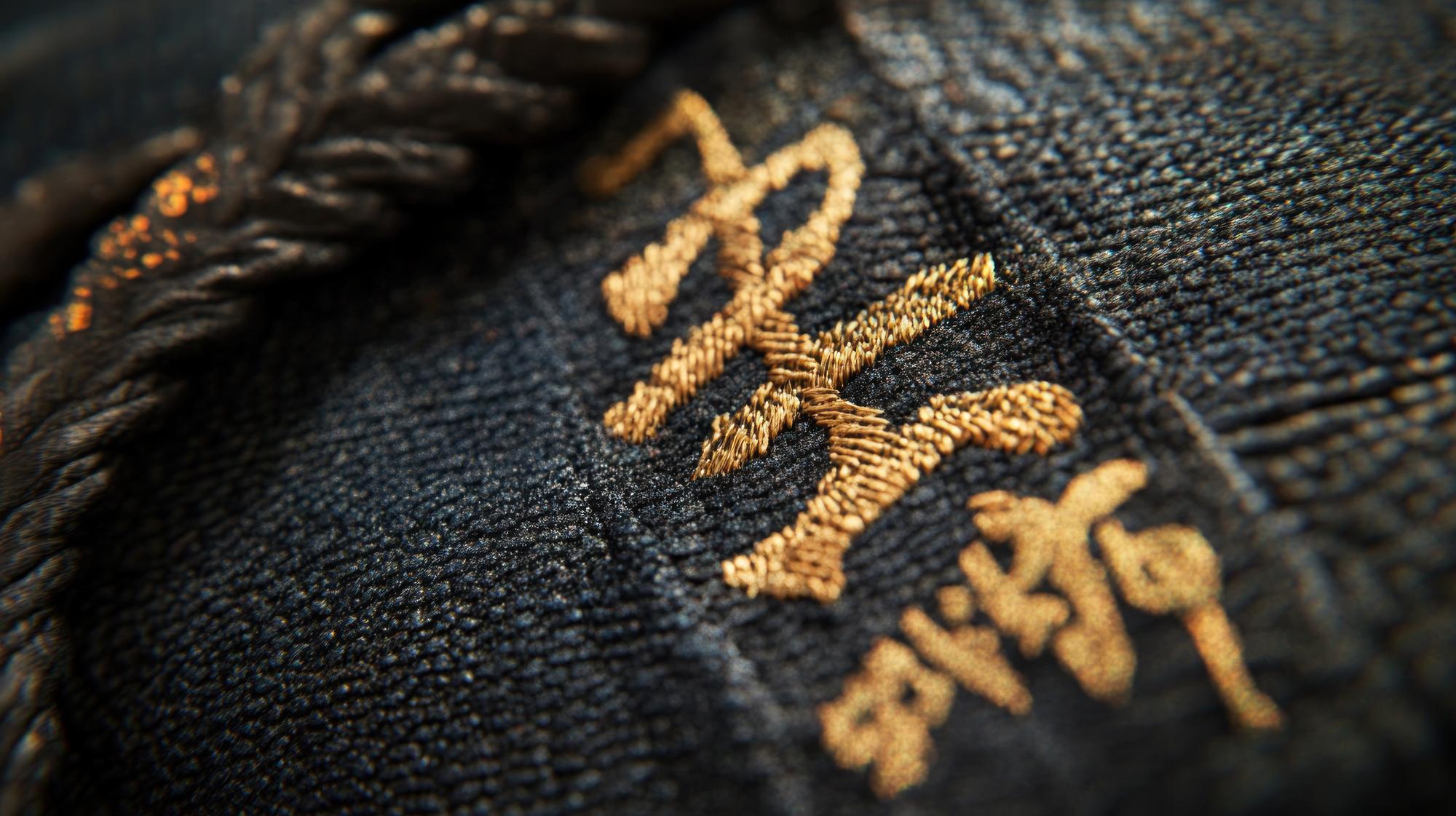 Close-up of gold-thread hand embroidery on silk